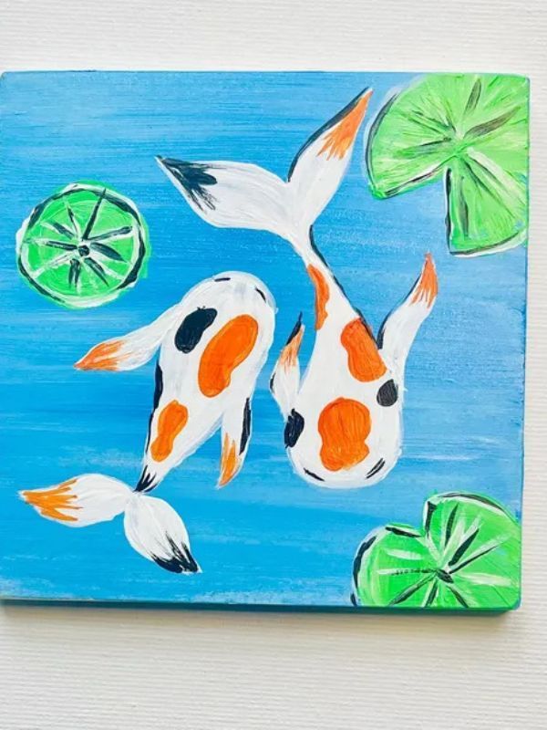 A painting of two fish and lily pads on a blue background