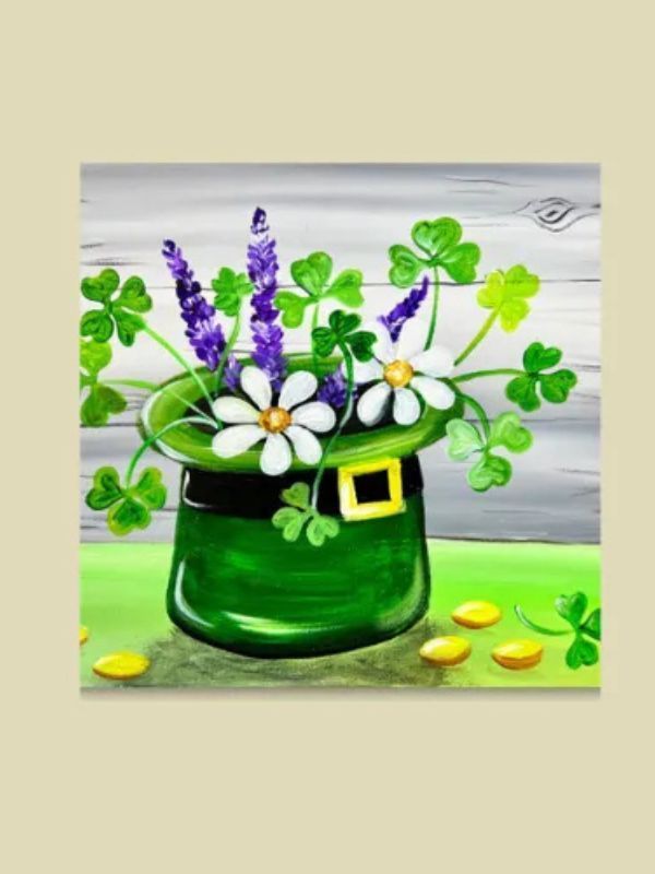 A green leprechaun hat filled with flowers and clovers.