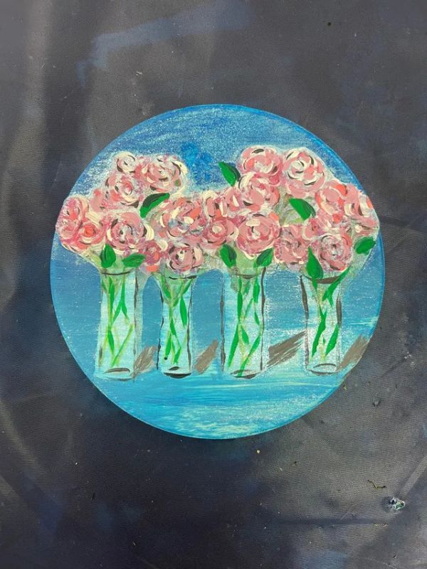 A painting of pink flowers in vases on a blue background