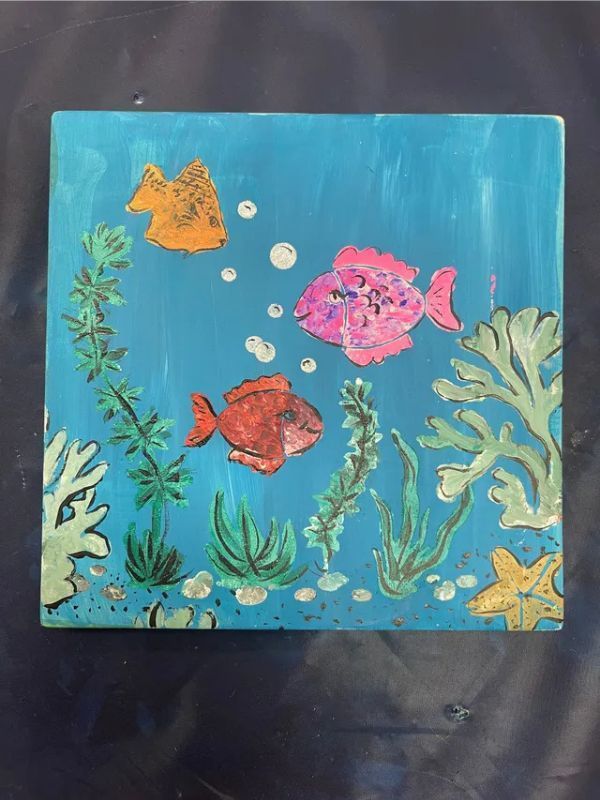 A painting of fish and seaweed on a blue background