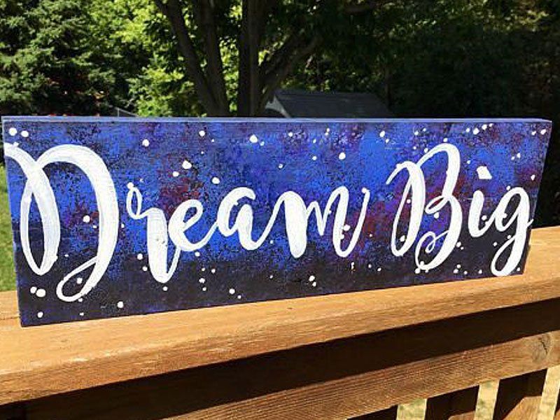 painted wood sign that says dream big