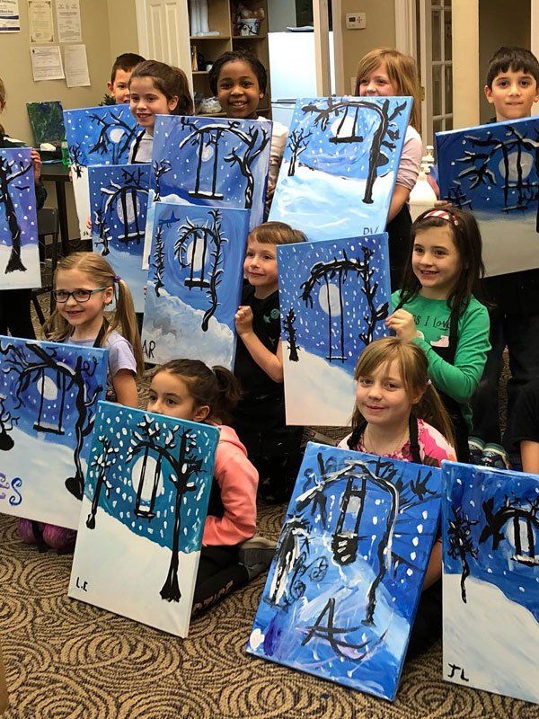 kids with their painted canvases