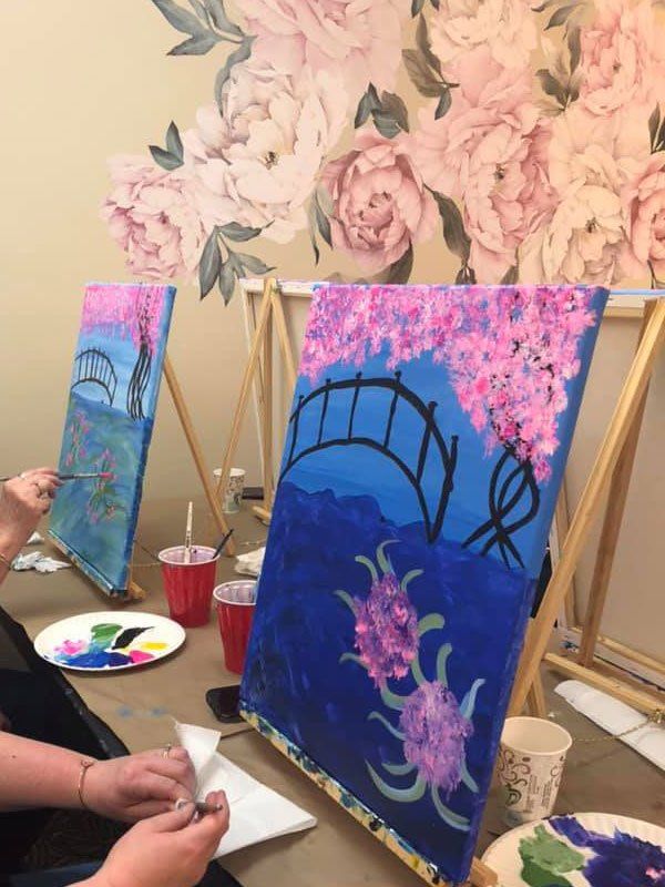 canvases being painted during an art class