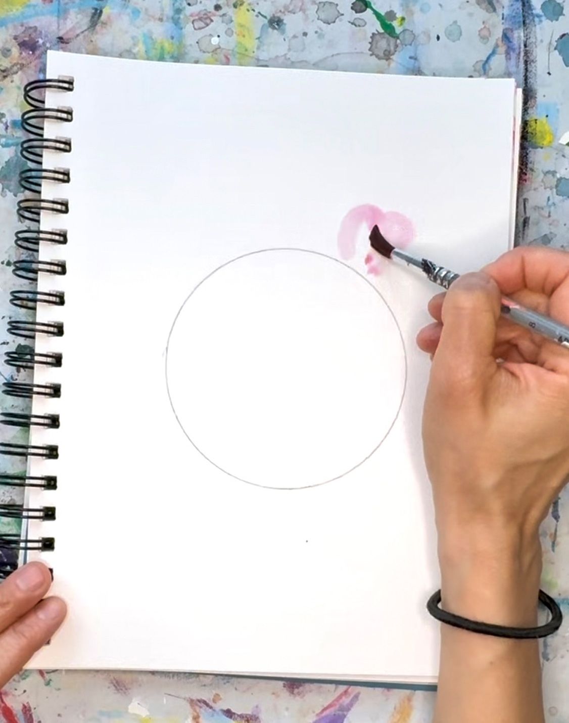 person creating water color flowers