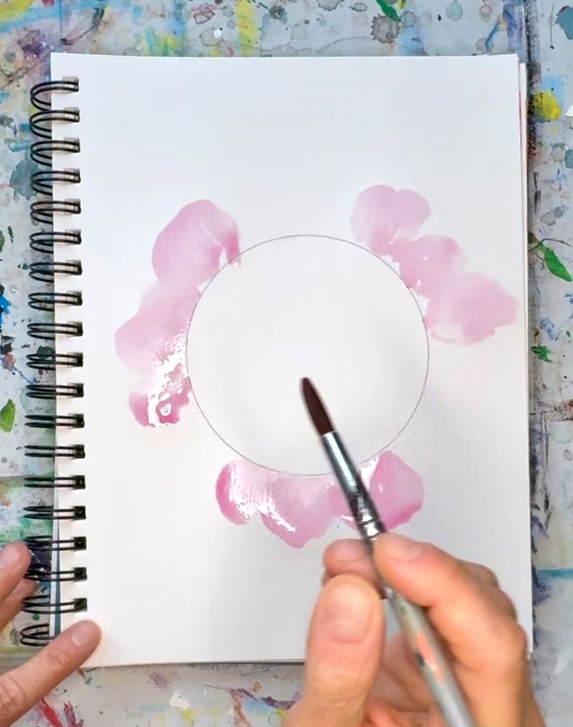 person creating watercolor petals