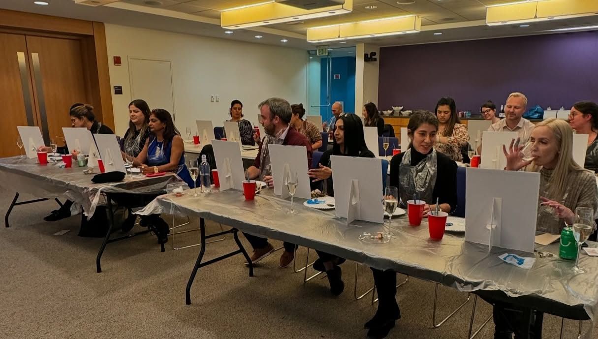 A group of people are sitting at tables in a room.