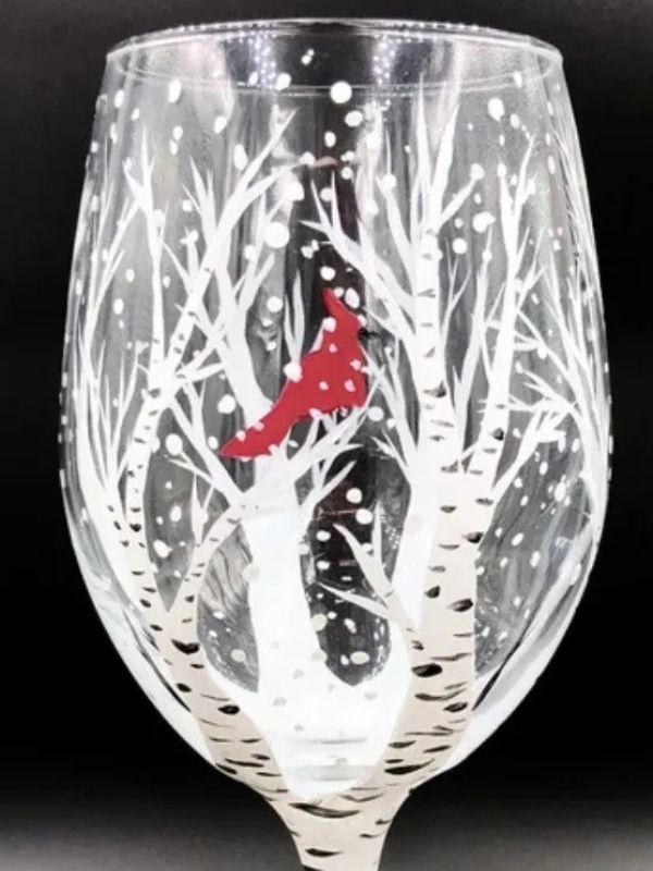 Cardinal perched in snowy birch tree painted on wine glass