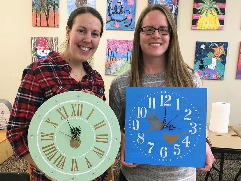 Friends Holding woodwork clock