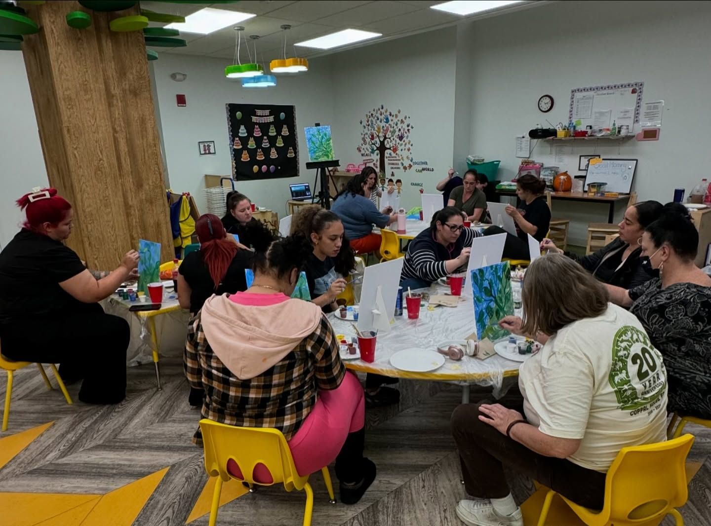 A group of people are sitting around a table in a room.