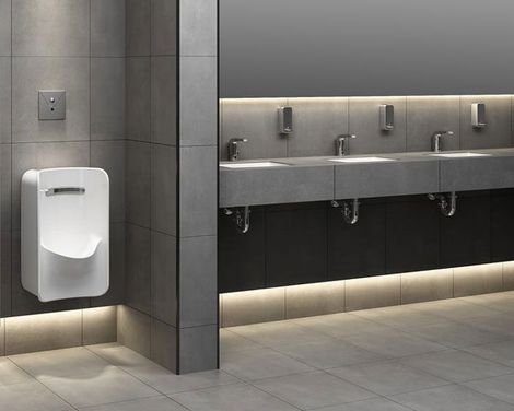 a commercial restroom with fixtures and sinks