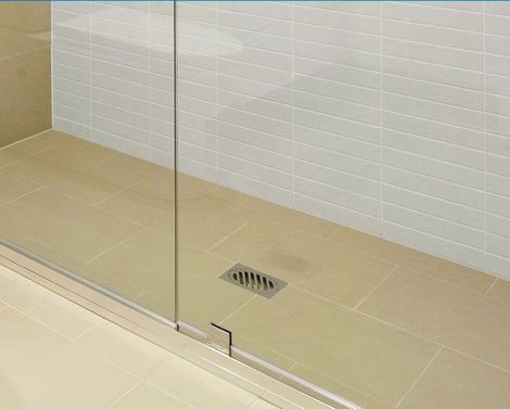 a shower stall with a drain on the floor