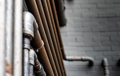 a close up of a row of pipes against a brick wall