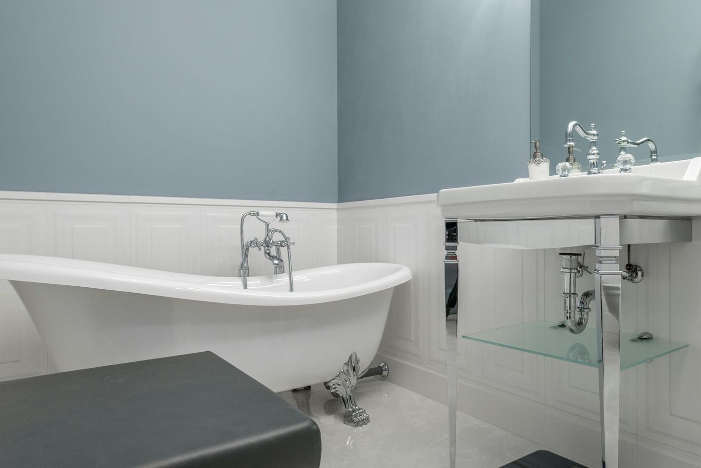 A bathroom with a bathtub , sink and mirror — Peak Plumbing and Gas Fitting in Yamba, NSW