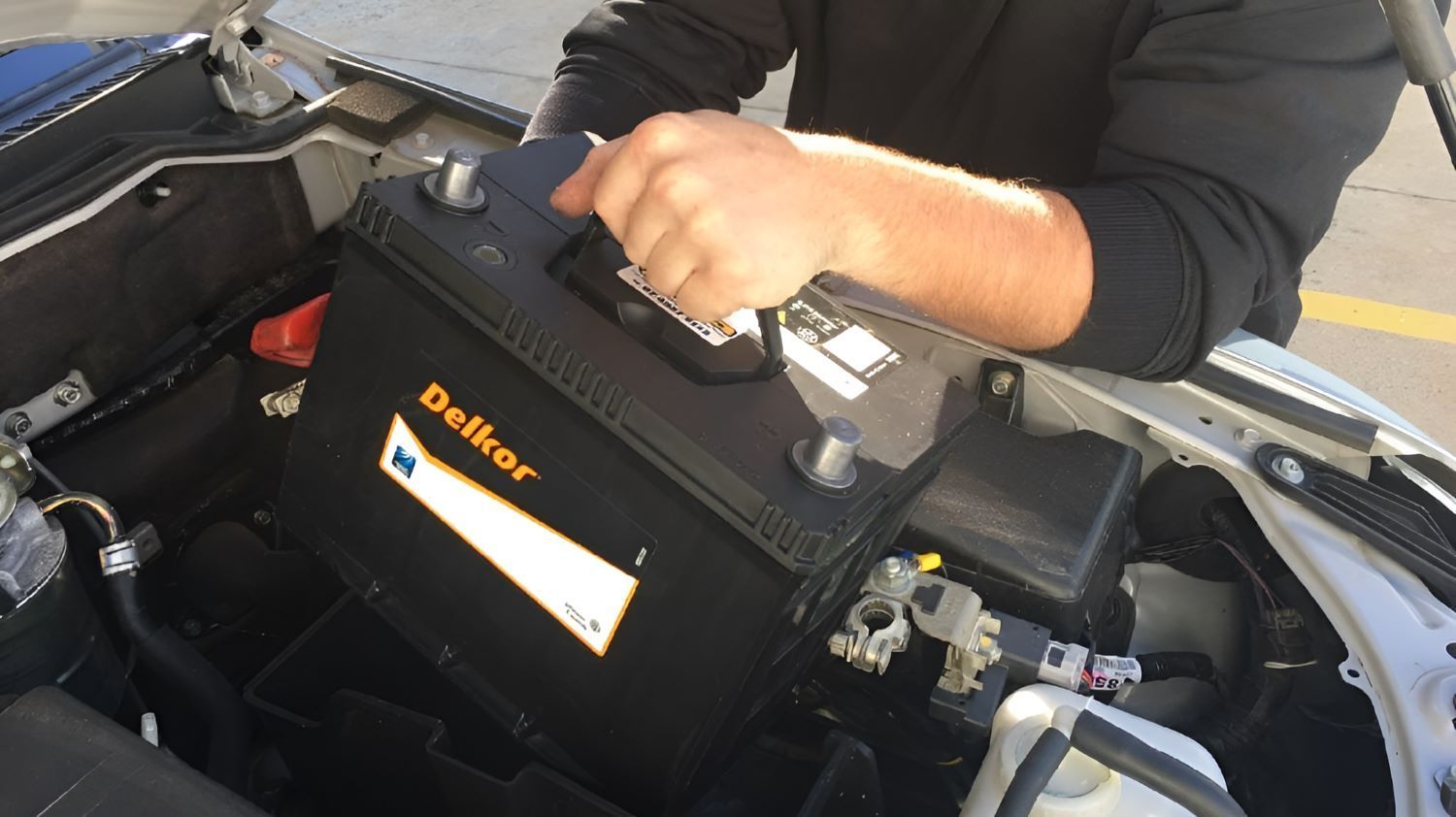 A Person Is Holding a Belker Battery — Wayne's Mechanical World in Pialba, QLD
