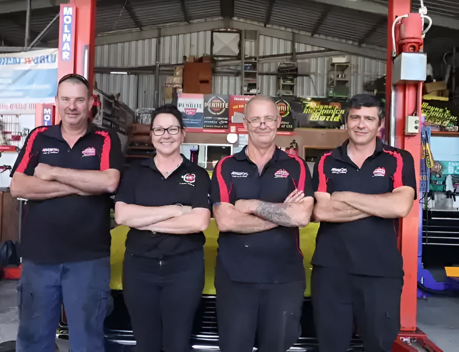 A Group of People Standing Next to Each Other — Wayne's Mechanical World in Pialba, QLD
