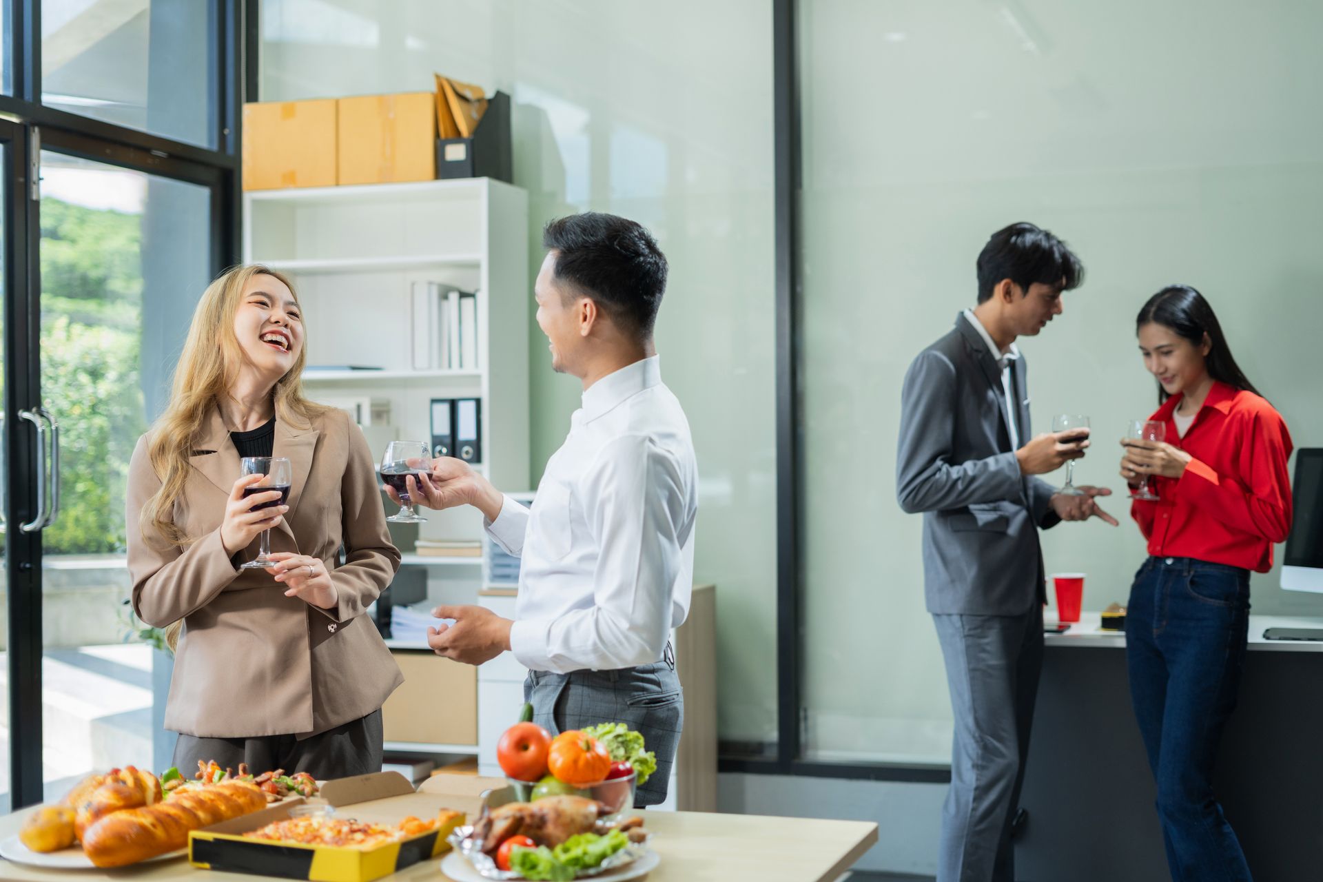 Happy team celebrating in a stocked office break room