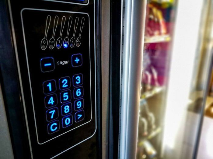 A close up of a vending machine with a keypad.