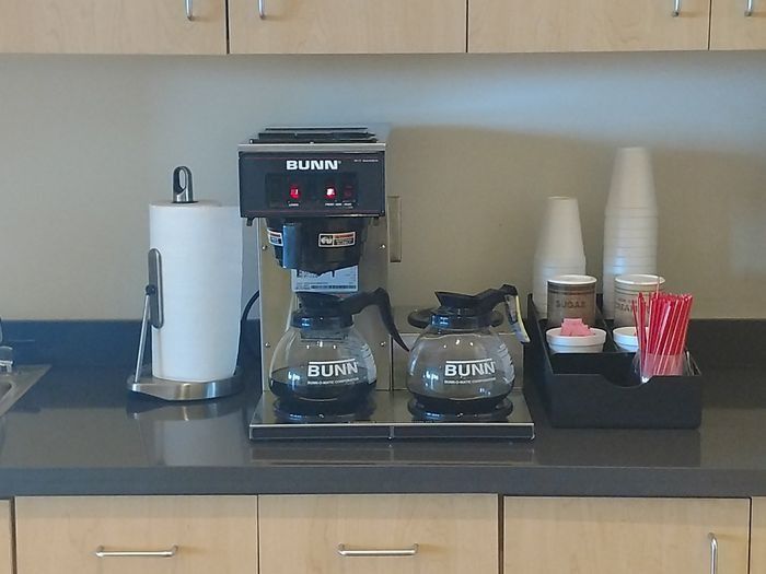 A bunn coffee maker sits on a kitchen counter