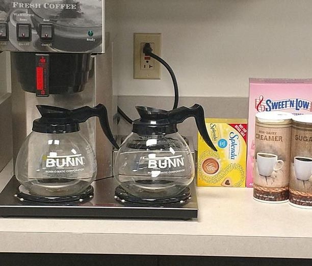 Two bunn coffee pots are sitting on a counter
