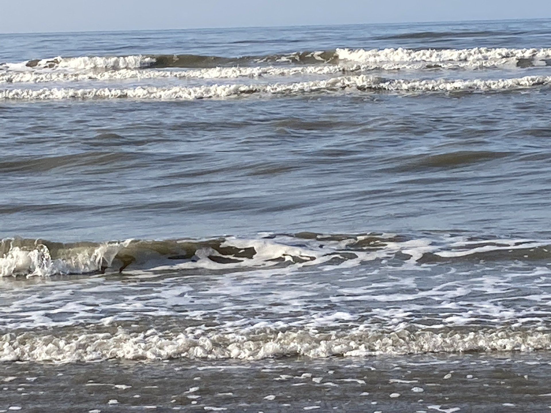 Eine Nahaufnahme von Wellen, die an einem Strand brechen