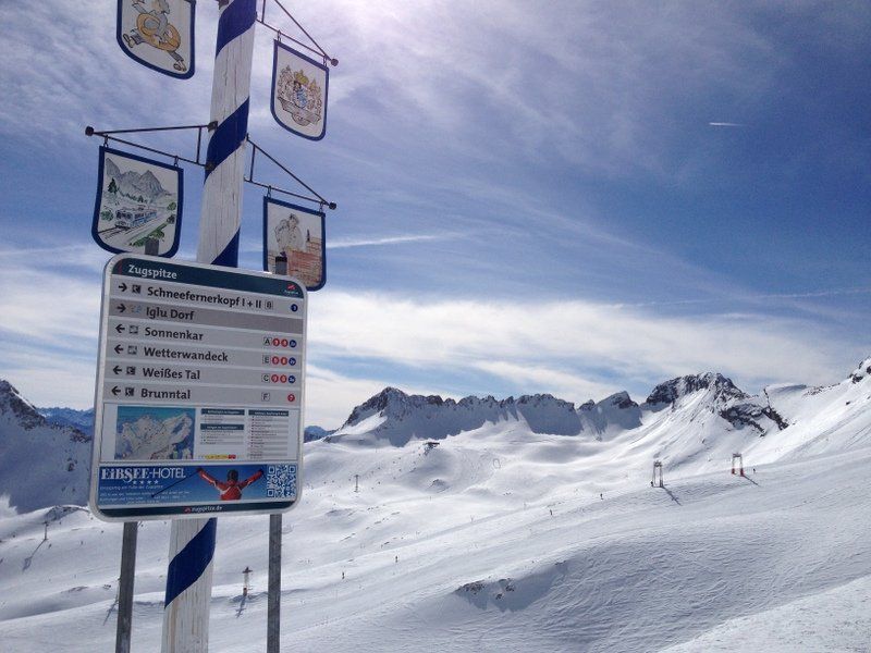 Ein Schild auf einem schneebedeckten Berg zeigt, wohin man gehen muss