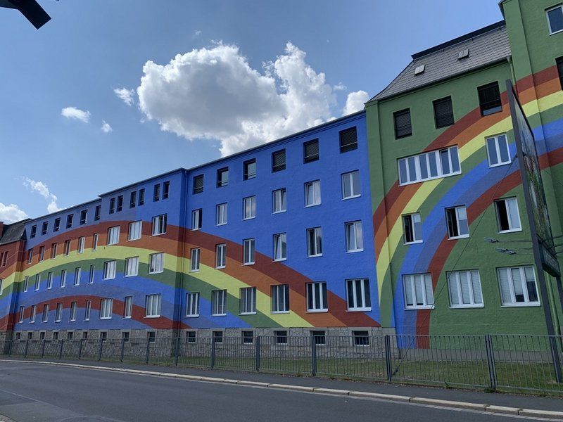 Ein Gebäude mit einem auf die Seite gemalten Regenbogen