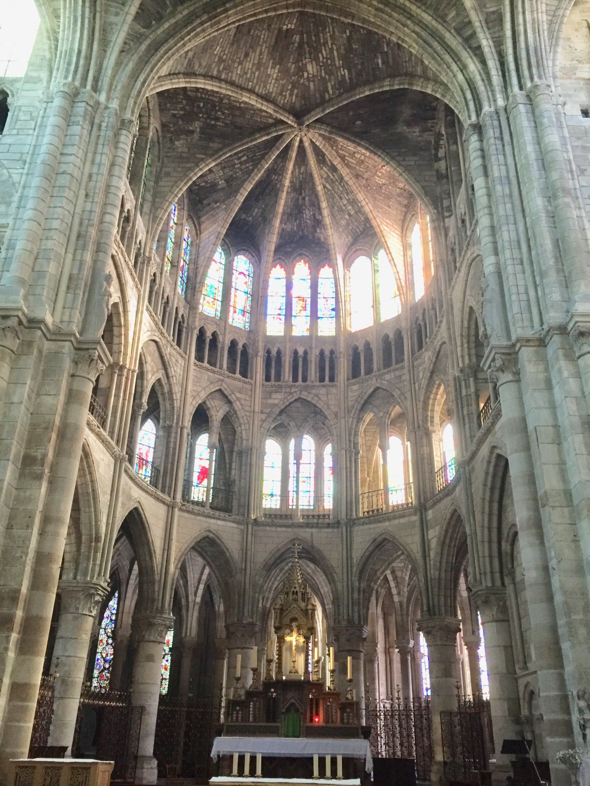 Das Innere einer Kirche mit Buntglasfenstern und Bögen.