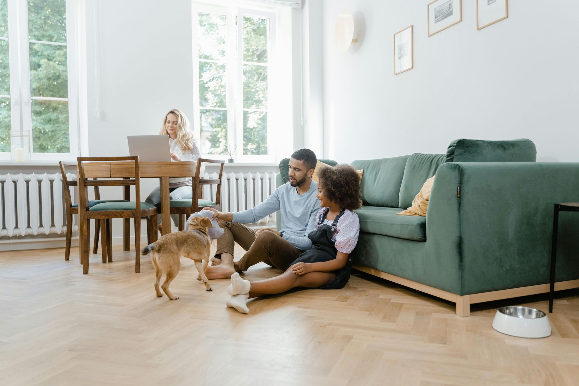 family enjoying a movie together in their living room, with soft, natural light coming through the windows without any glare on the screen - film anti glare