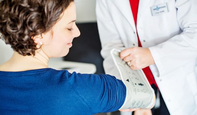 Female Doctor with Senior at Electrotherapy for Pain Relief Stock