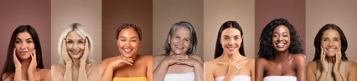 Seven people with diverse skin tones pose against coordinating neutral backgrounds, each smiling with hands near their face.