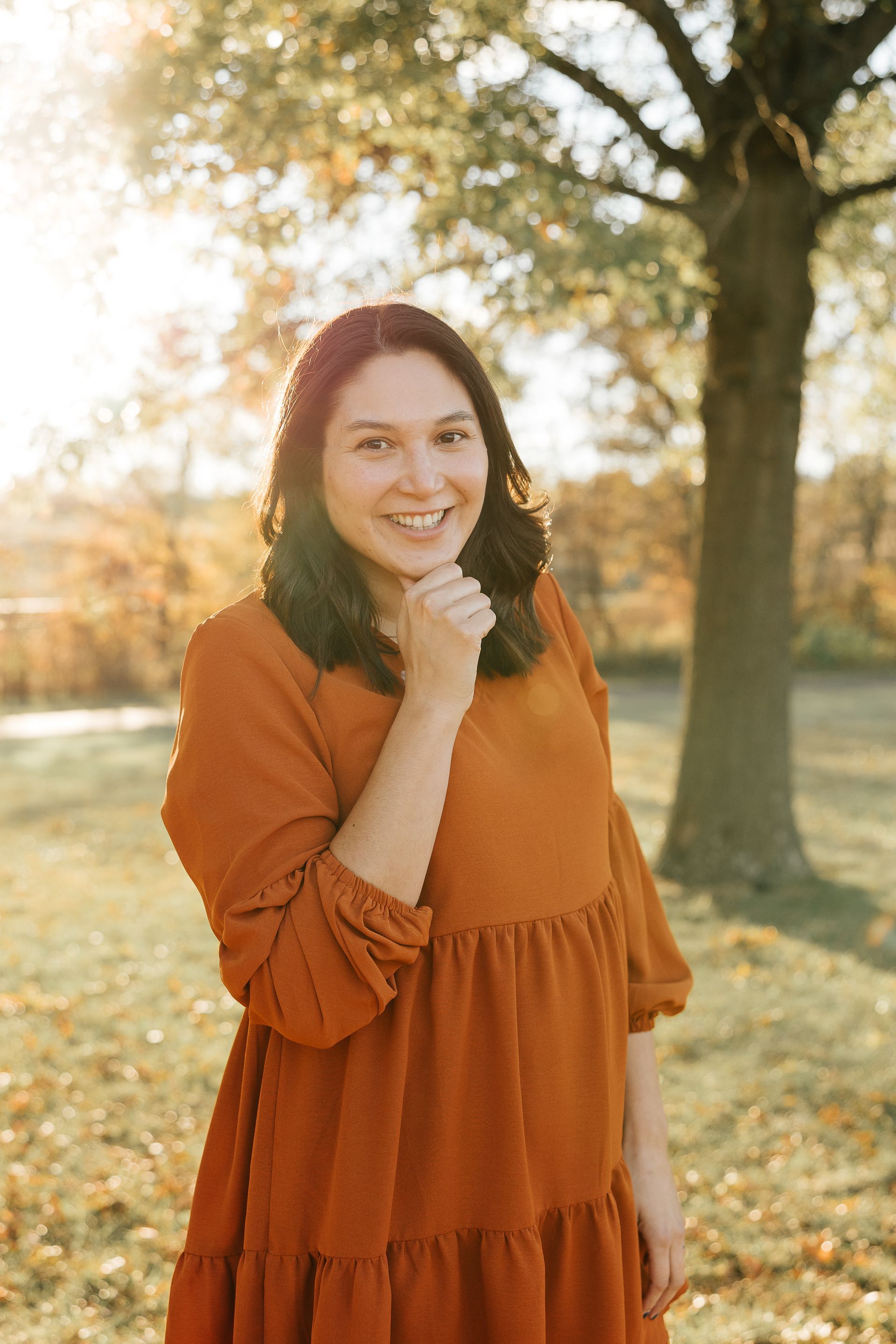 A waiting room in a building of offices with a couch , chairs , and a pond in the middle of a building.