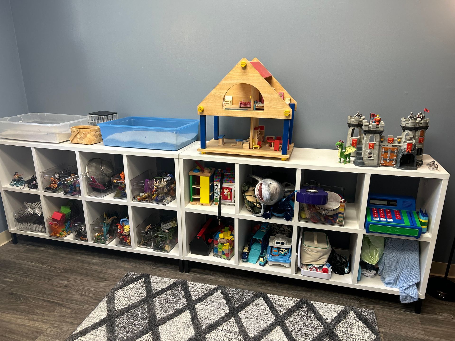 Peck Counseling's assortment of toys for play therapy and more sitting on a small, open dresser.