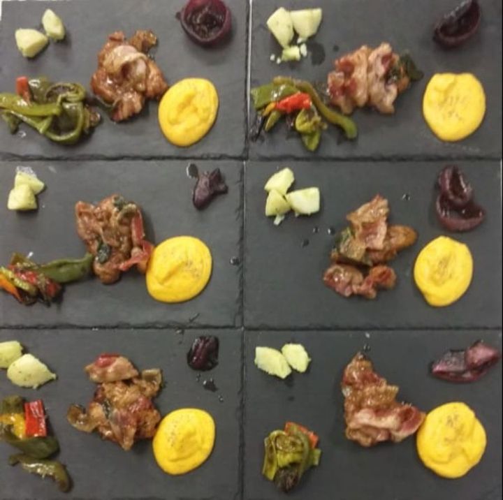 Various appetisers on a black cutting board