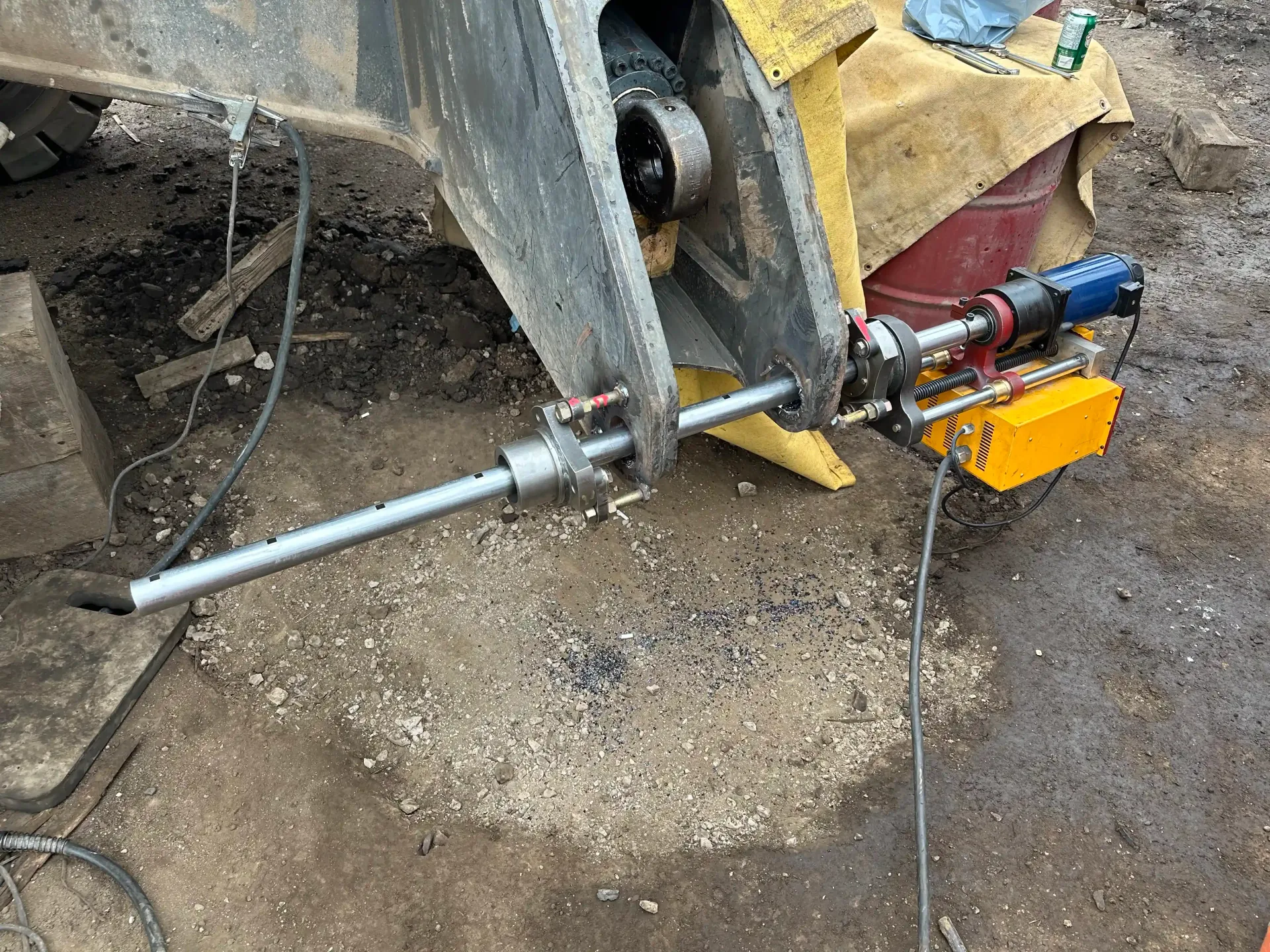 A machine is sitting on the ground next to a truck.