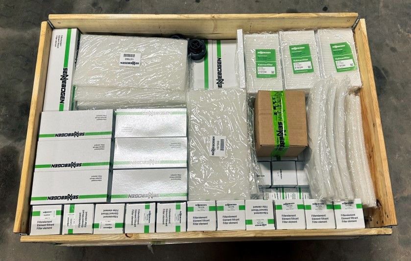 A wooden box filled with lots of boxes and packages.