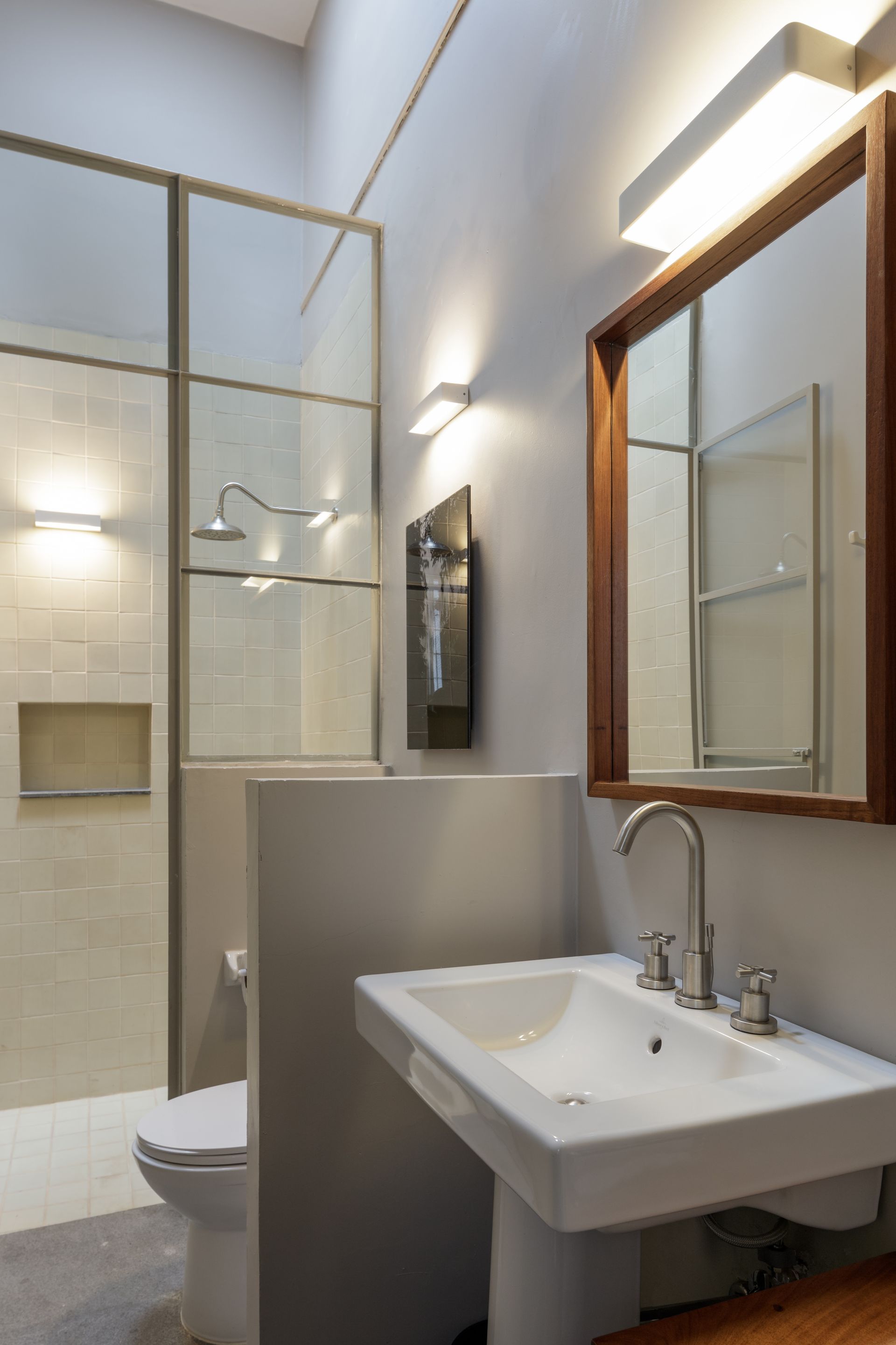 A bathroom with a sink , toilet and shower.