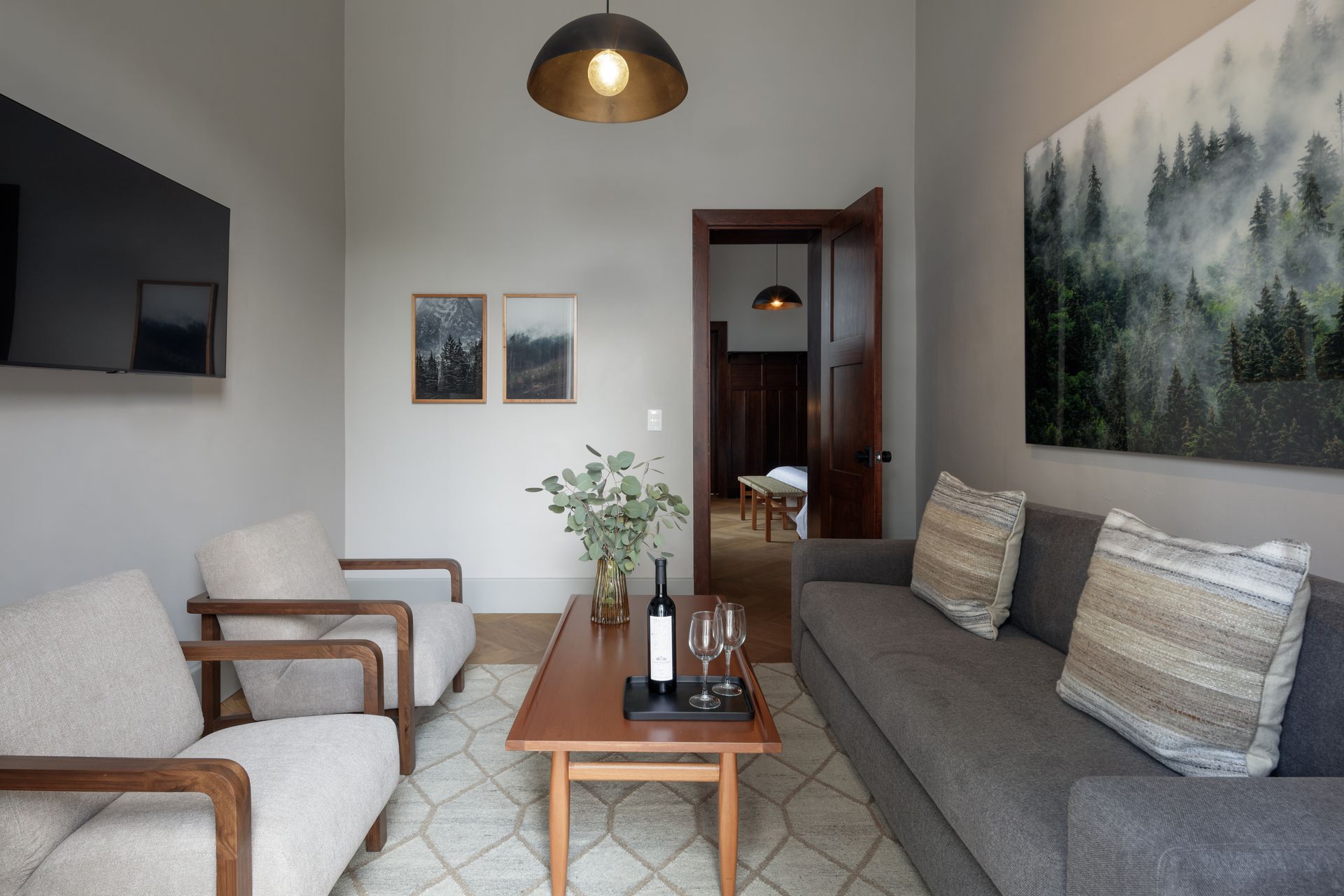 A living room with a couch and two chairs