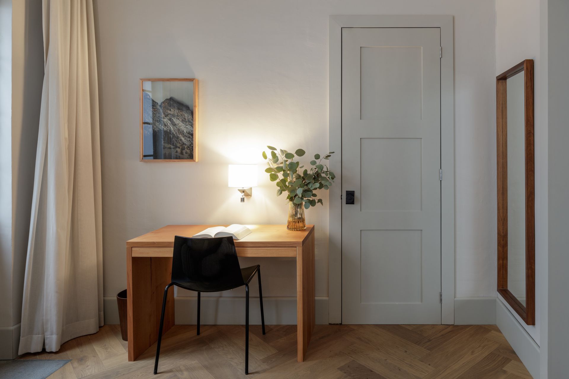 There is a desk and chair in the room.