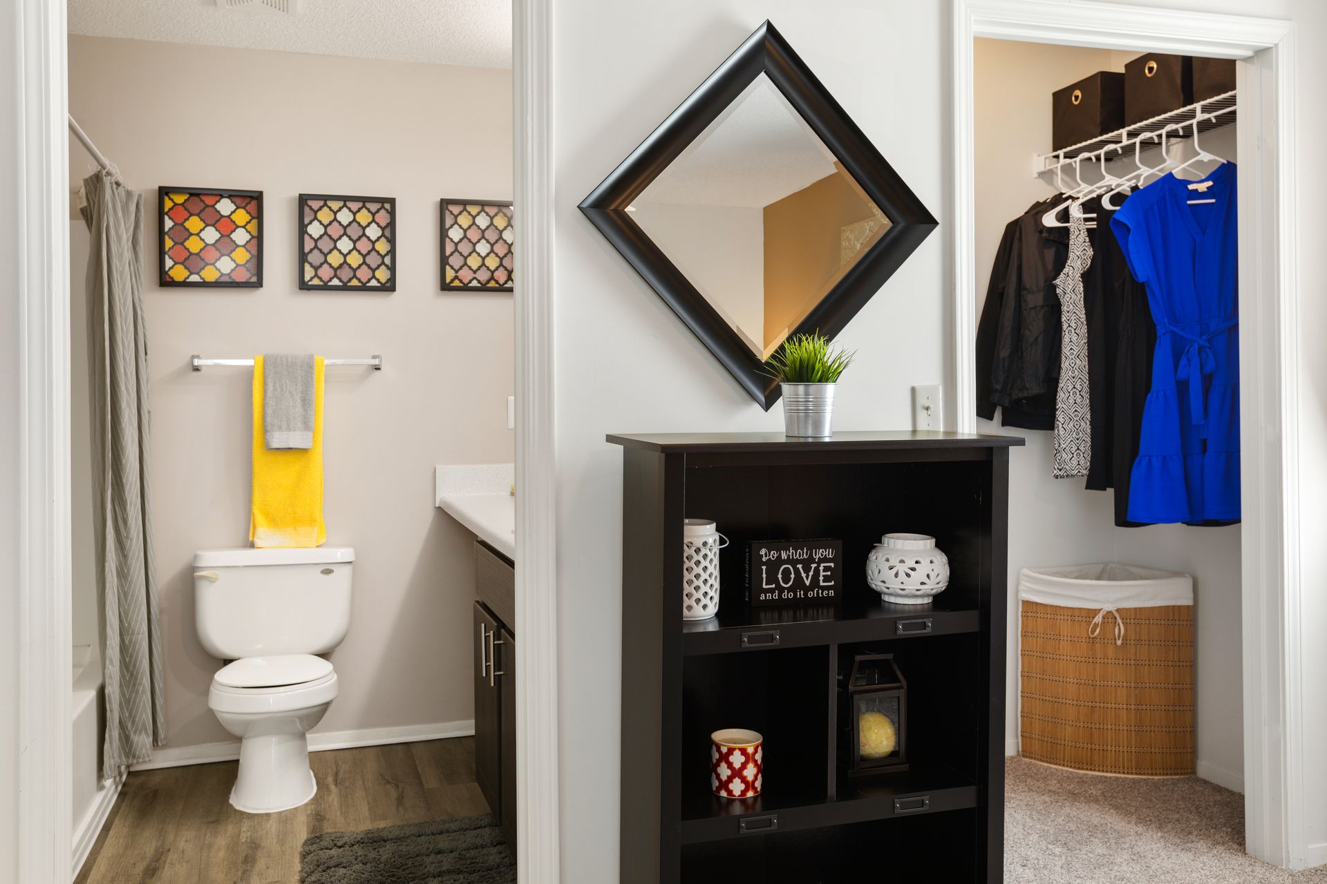 A bathroom with a toilet , sink , mirror and closet.