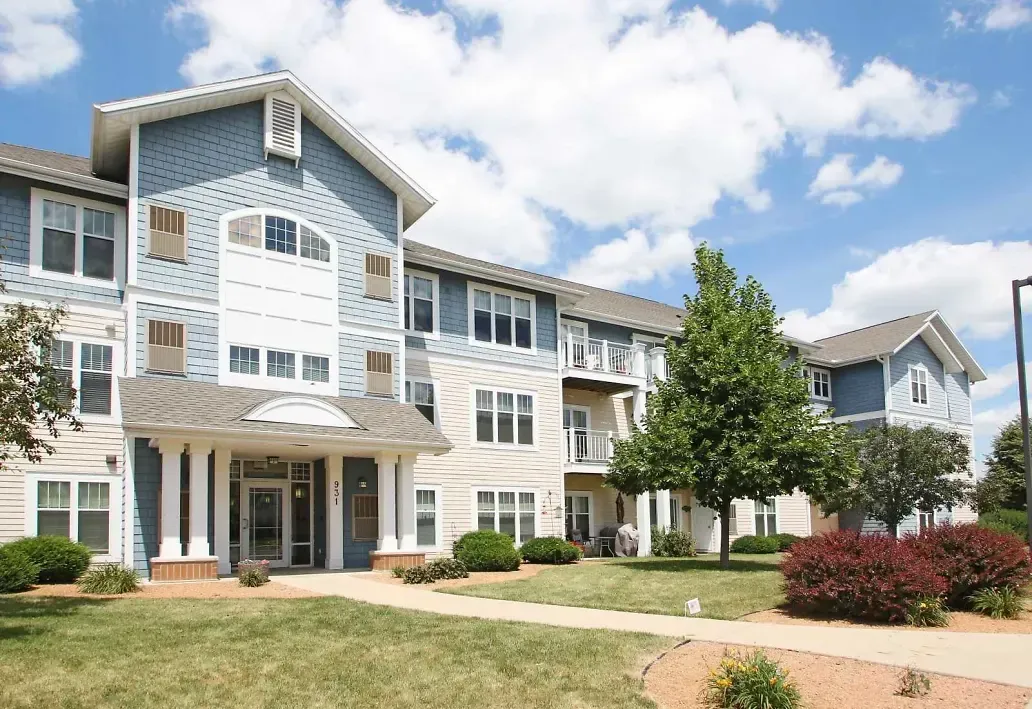 A large apartment building with blue siding and white trim