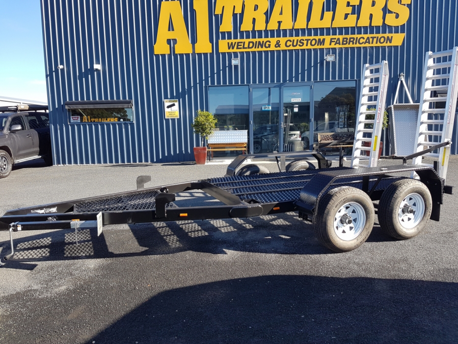 A trailer is parked in front of a trailers building