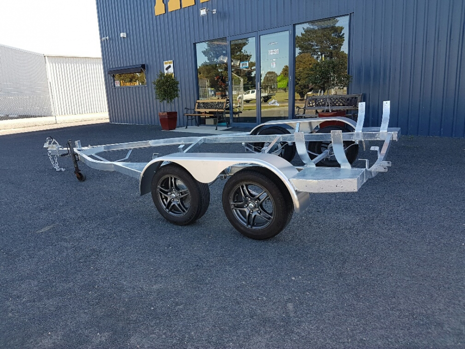 A trailer is parked in front of a building.