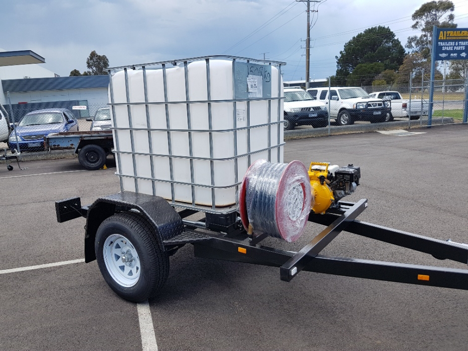A trailer with a large white tank on it is parked in a parking lot.