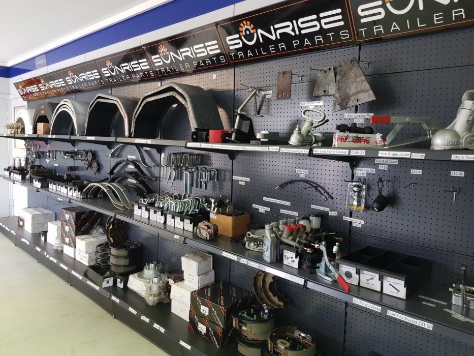 A showroom filled with lots of trailer parts on shelves.