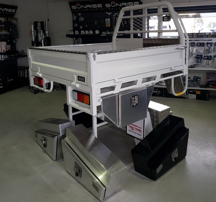 A white truck bed with a bunch of drawers underneath it