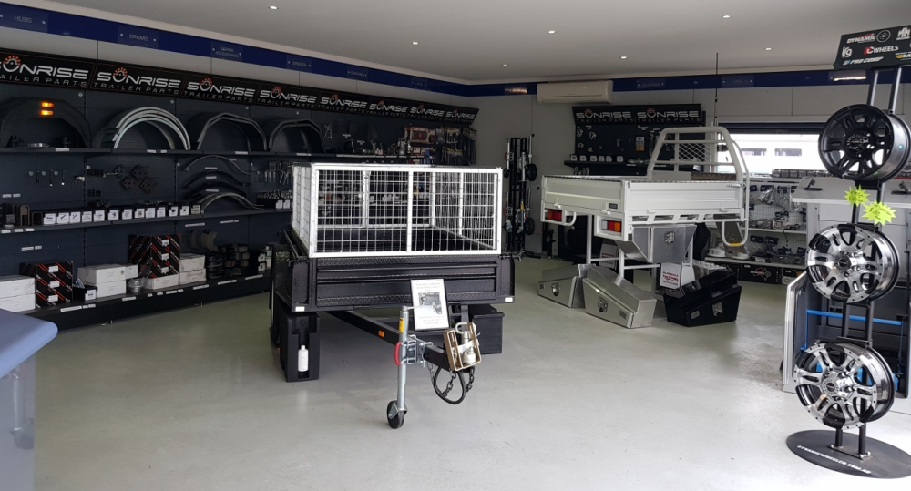 A showroom filled with lots of trailers and wheels