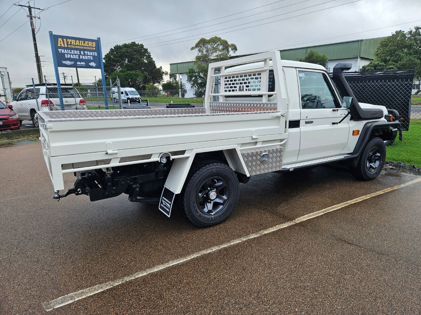 A trailer is parked in front of a trailers building