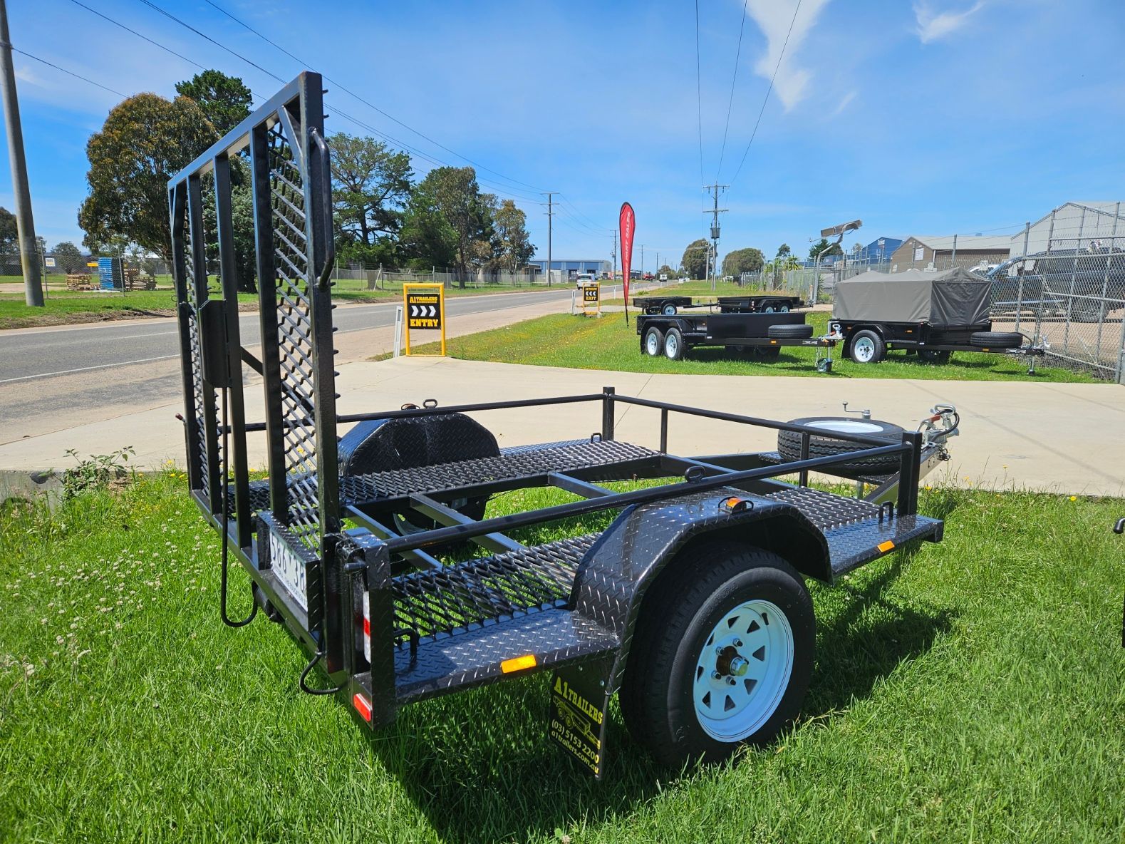 A trailer is parked in front of a building.