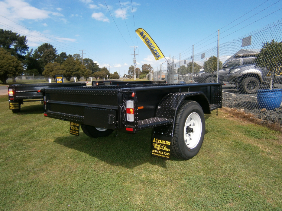 A black trailer with a yellow banner on top of it