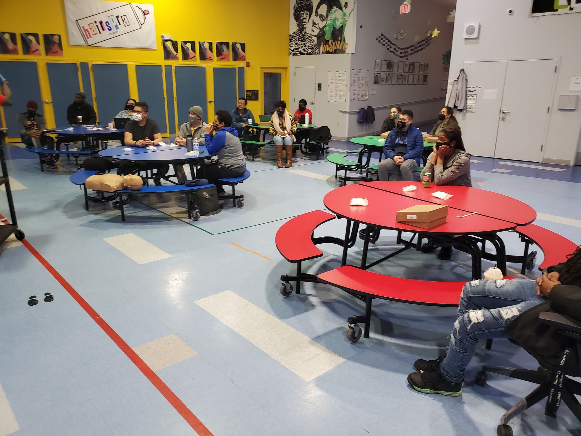 A group of people are sitting at tables in a room